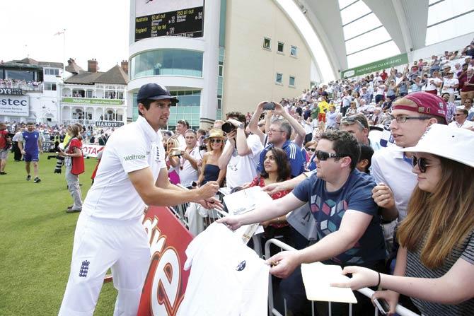 England captain Alastair Cook signs autographs for fans after his team beat Australia in the fourth Ashes Test by an innings and 78 runs at Trent Bridge in Nottingham on Saturday. Pic/AFP