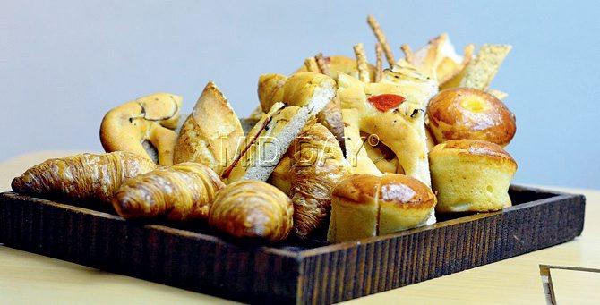 Assorted bread basket with brioche, za’taar lavash, croissant