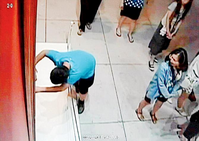 Fool and the fall! A CCTV footage shows the boy trip over a platform in front of the artwork and then brace himself against the painting to break his fall. PIc/Youtube video grab