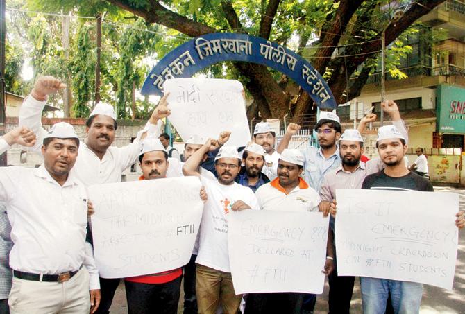 Aam Aadmi Party workers protest outside the institute. pics/pti