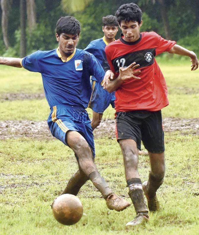 Thakur College’s Harsh Rall (blue) and Zidone D’Souza vie for the ball at the Sports Authority of India ground in Kandivli on Saturday