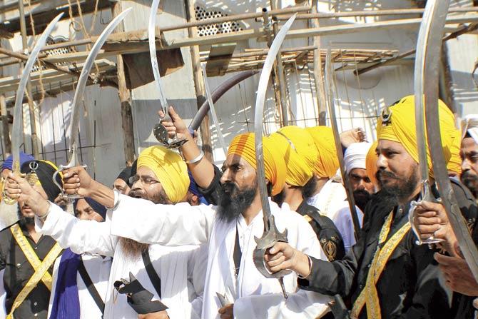 Sikh activists hold swords in support of Khalistan, the name given for the envisioned independent Sikh state, at the Golden Temple in Amritsar on June 6, 2013. Pic/AFP