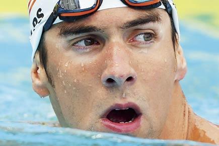 Michael Phelps eases into 100m final