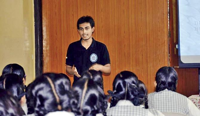 A volunteer gives an awareness talk to students at a Mumbai school