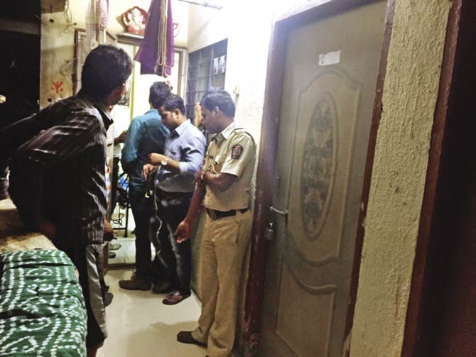 Police officials at the Nallasopara residence of 27-year-old Ambala Devnath. The kidnappers have demanded Rs 1.5 lakh to free his 7-year-old son