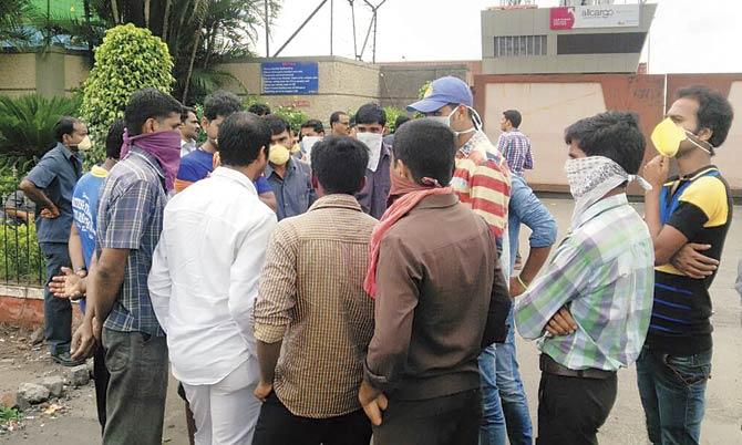 Workers at the Nhava Sheva terminal where three workers allegedly died from the stench of rotting beef