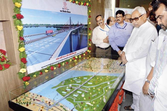 Bihar Chief Minister (CM) Nitish Kumar looking at a model before inauguration of the starting of different schemes at Adhiveshan Bhawan, in Patna