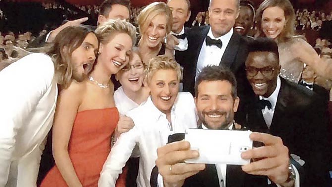 Ellen de Generes (in white suit) and the selfie at the Oscars that was a global rage