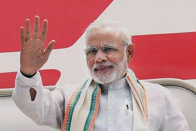 Prime Minister Narendra Modi waves before his departure from New Delhi on Sunday for the UAE. Pic/PTI