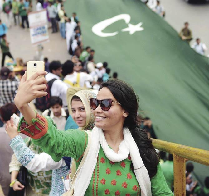 A Pakistani student takes a selfie during a march in Karachi on Thursday, ahead of the country’s 68th Independence Day celebrations. On this Independence Day, Pakistanis should reflect on why human rights organisations, activists and some in the media are the only ones raising their voice over the child abuse scandal, while everyone else is concerned with saving the ‘image’ of Pakistan. Pic/AFP