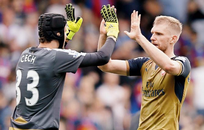 Arsenal goalkeeper Petr Cech (left) and teammate Per Mertesacker celebrate their 2-1 win over Crystal Palace in London yesterday. pic/afp