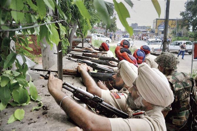 Punjab Police fire at armed attackers who swarmed a police station at Dinanagar, in the Gurdaspur district of Punjab on July 27. Pic/AFP