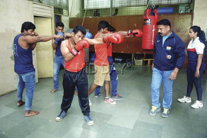 Vikramsinha Padwal (right) trains 15-odd boxing enthusiasts enrolled in the Ex Services Sports School, which was once a large sports facility that trained national-level boxers, but has since fallen on hard times. Pic/Pradeep Dhivar