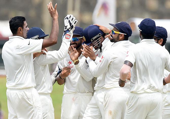 Indian cricketers celebrate a wicket