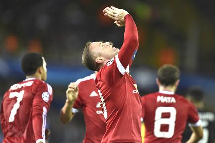 Rooney treble seals Manchester United's Champions League berth