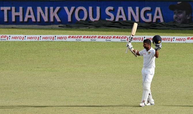 Sri Lankan cricketer Kumar Sangakkara raises his bat as he walks to the pavilion after being dismissed during the fourth day of the second Test cricket match between Sri Lanka and India at the P. Sara Oval Cricket Stadium in Colombo on August 23, 2015. Pic/AFP