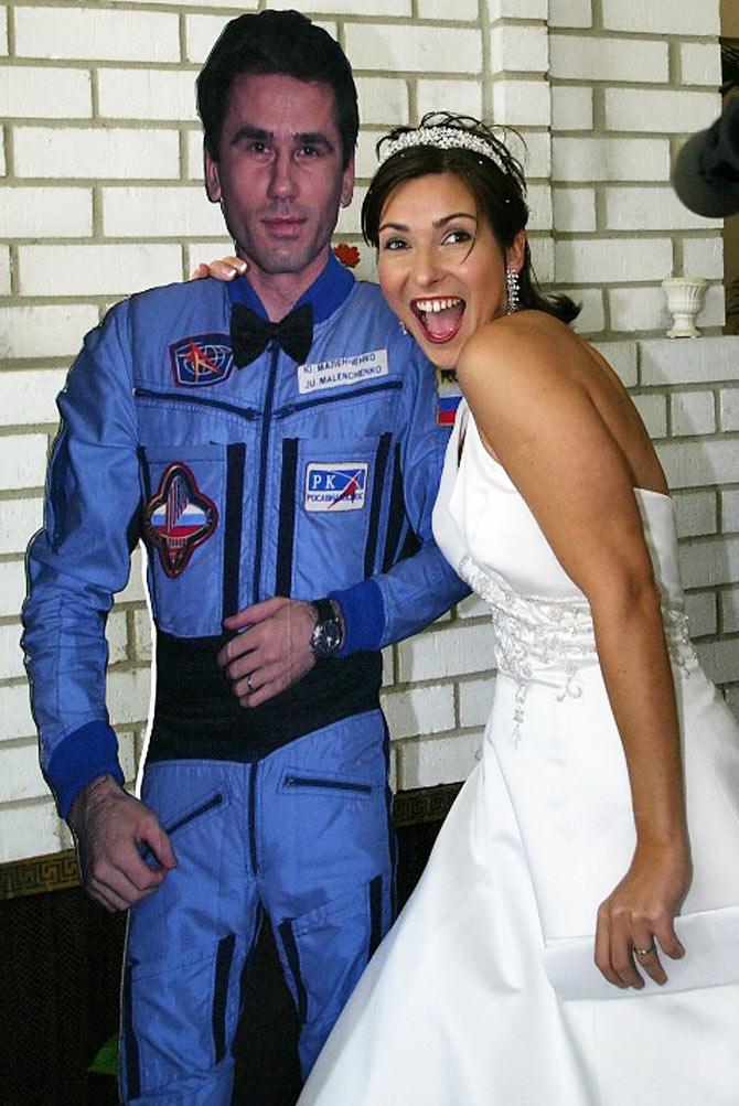 Yekaterina Dmitriyeva, the bride of Russian cosmonaut Yuri Malenchenko, poses with a life-sized cutout of her new husband at a press conference in Seabrook, Texas after the ceremony in August 10, 2003. Pic/AFP