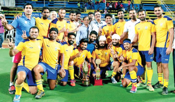 BPCL players pose after winning the Dabang Mumbai-50th All India Bombay Gold Cup hockey tournament yesterday