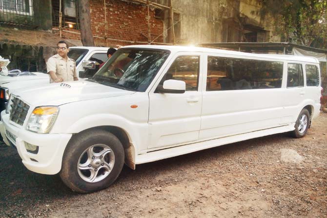 An RTO official with the seized vehicles. Both the vehicles are 1.8 metres longer than a standard Scorpio
