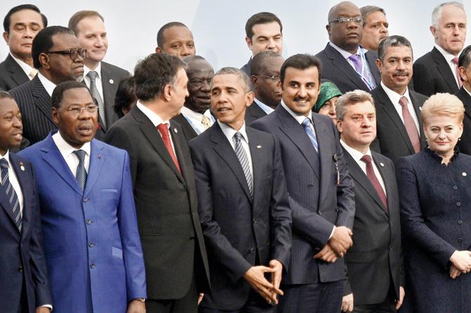 US President Barack Obama is greeted by world leaders as he arrives for a group photo at the CoP21 yesterday in Le Bourget, on the outskirts of Paris. Pic/AFP