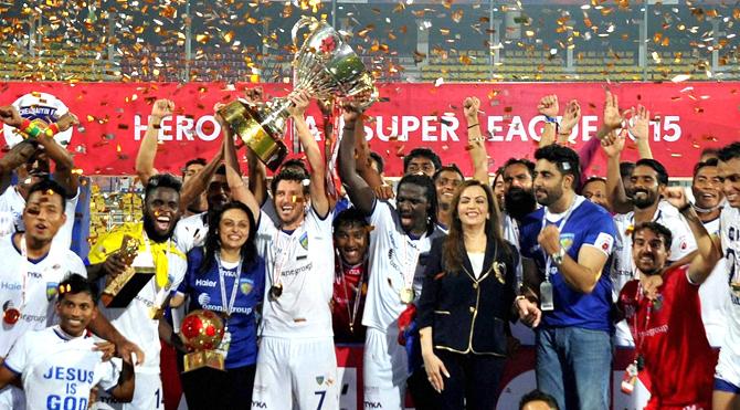 Chennaiyin FC players celebrate with the winning trophy after defeating FC Goa by 3-2 in the finals of the 2nd edition of the ISL