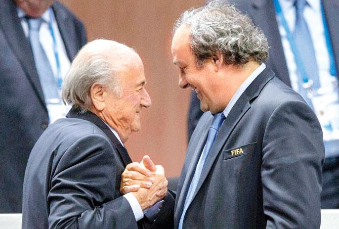 May 29, 2015: FIFA chief Sepp Blatter is greeted by UEFA President Michel Platini (right) after Blatter
