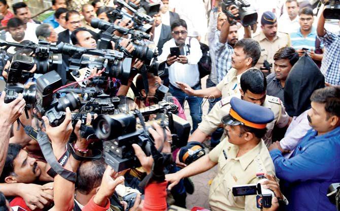 Chintan Upadhyay is escorted to Borivli Metropolitan Court by cops on Tuesday, where he was remanded to police custody till January 1. Pic/Nimesh Dave