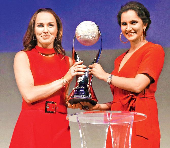 Martina Hingis & Sania Mirza with the 2015 WTA Finals trophy in Singapore. Pic/Getty Images
