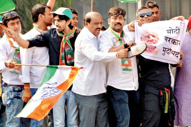 Congress workers stage a protest against the BJP government at Kherwadi junction, accusing the ruling party of targeting its leadership and resorting to vendetta politics in the National Herald case. FILE PIC