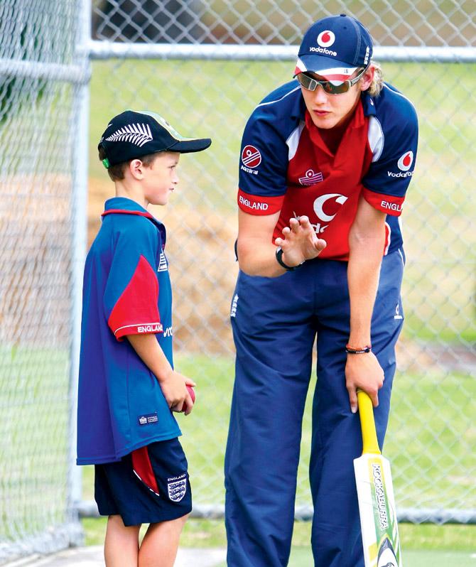 England star Stuart Broad passes on some tips during a coaching clinic for children at Sacred Heart College in Auckland on  February 16, 2008. Pic/Getty Images