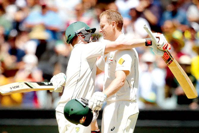 Adam Voges (right) is hugged by Steve Smith after making a century on Day Two against West Indies at the MCG yesterday. Pic/Getty Imag