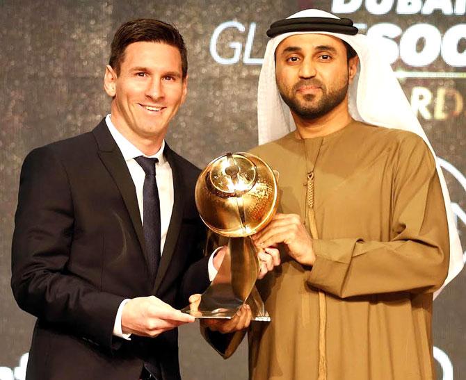 Barcelona striker Lionel Messi (L) receiving the trophy for best player of the year during the Dubai Globe Soccer award at the end of the Dubai International Sports Conference in the United Arab Emirate of Dubai. Pic/AFP