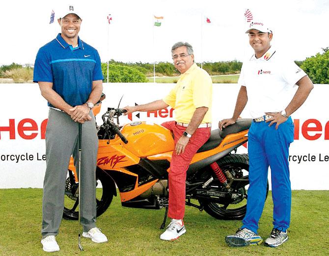 Pawan Munjal, Chairman, MD and CEO of Hero MotoCorp (centre) with Tiger Woods and India