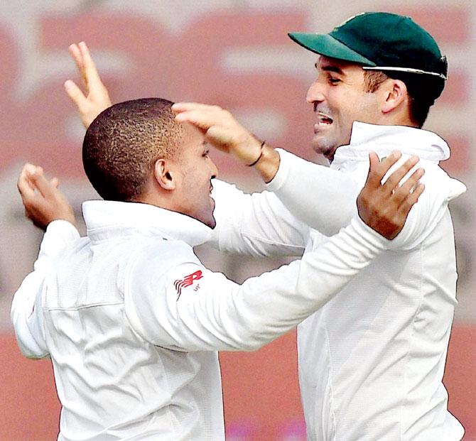 Dane Piedt (left) celebrates the wicket of India’s Murali Vijay with teammate Dean Elgar yesterday. Pic/AFP