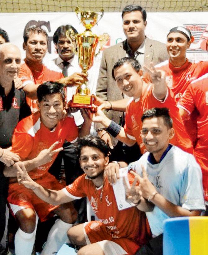 The victorious Poisar Pirates team pose with the trophy and chief guest Dhanraj Pillay (third from left)
