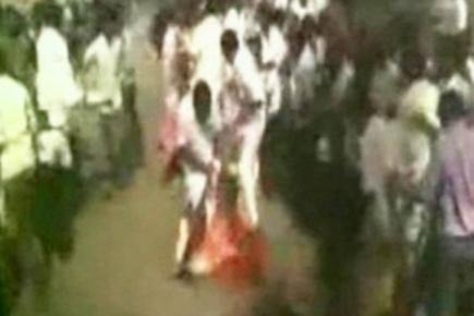 AIADMK worker's 'lungi' catches fire during protest against Vijayakanth 