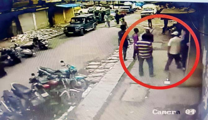 A CCTV grab of cops (circled) exiting Altaf Sheikh’s shop and heading for Salim’s car (circled) parked near Altaf’s Goregaon office on June 29