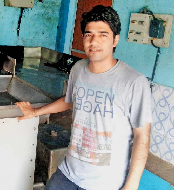 Arvind Jangid, a student involved in the project, with the biogas plant