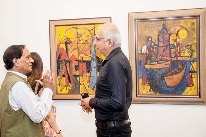 Avinash Chandra (right) chats with a guest at a preview of his works