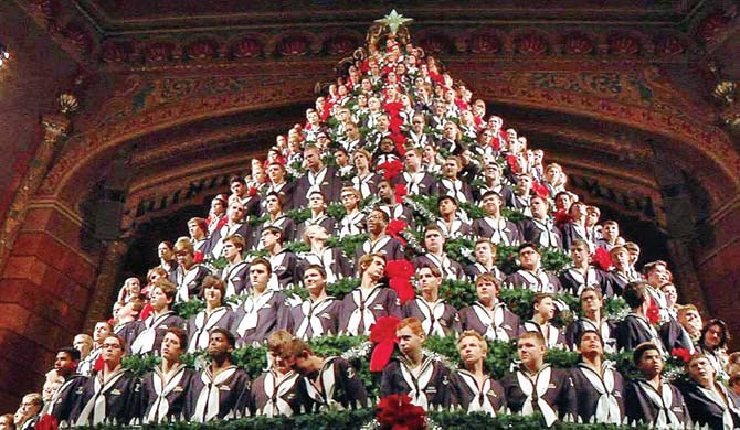 Students stand in the Singing Christmas Tree. Pic/AFP