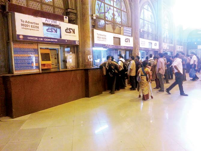 Despite presence of a COTVM, commuters prefer to wait in queues to purchase train tickets at CST. File pic