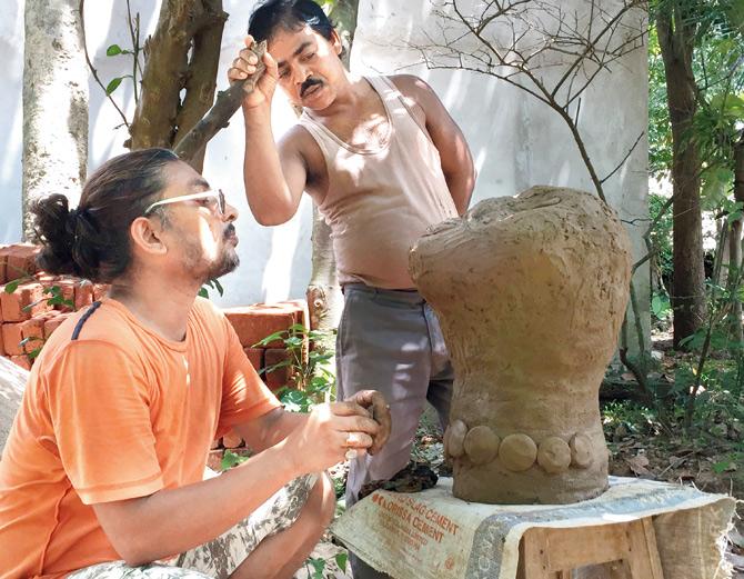 An artist working on a clay installation at a D.I.S.C The Art residency programme in Odisha