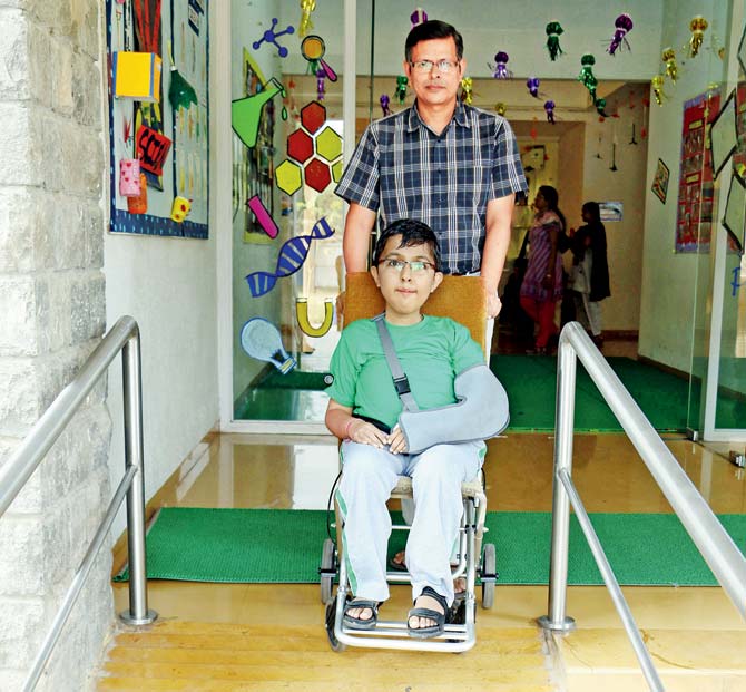 Niramay Khimasia, 12, from Chembur, is assisted by his father down the ramp. He has muscular dystrophy and is a Std VI student