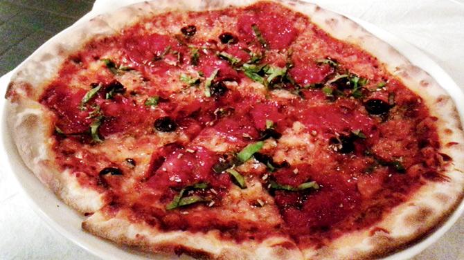 Picante pizza topped with spicy salami and olives