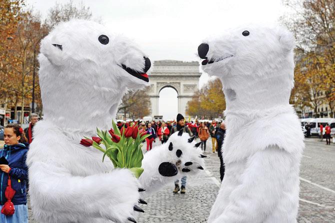 Activists dressed as polar bears at the Avenue de la Grande boulevard in Paris on Saturday. Pic/AFP