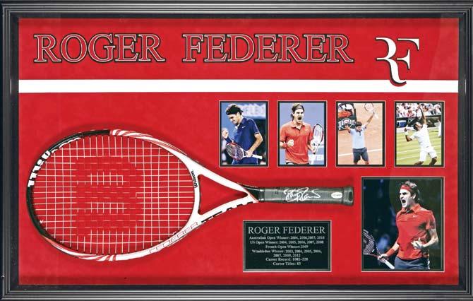 Roger Federer’s  racquet and (left) a ball signed by Tiger Woods