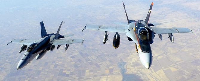 File photo of two US Navy F-18E Super Hornets supporting operations against IS over Iraq after conducting an air strike. Pic/AFP