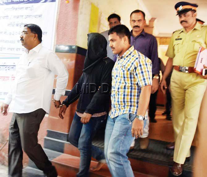 Tempo driver Vijay Rajbhar being escorted to court from the Kandivli police station yesterday