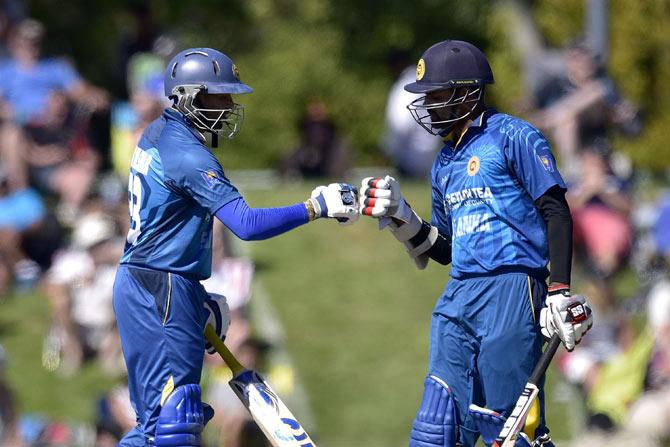Tillakaratne Dilshan (L) of Sri Lanka celebrates a four with teammate Lahiru Thirimanne