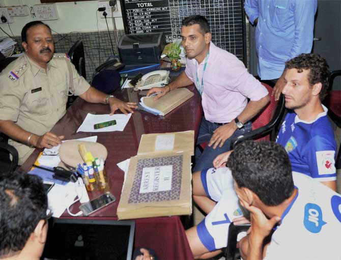 Police arrest Brazilian Elano Blumer (in blue jersey), marquee player of Chennaiyin FC as he assaulted Dattaraj Salgaonkar, the co owner of FC Goa, in